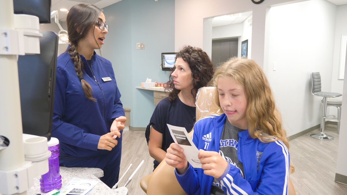 Team Demas assistant talking to a patient's mom